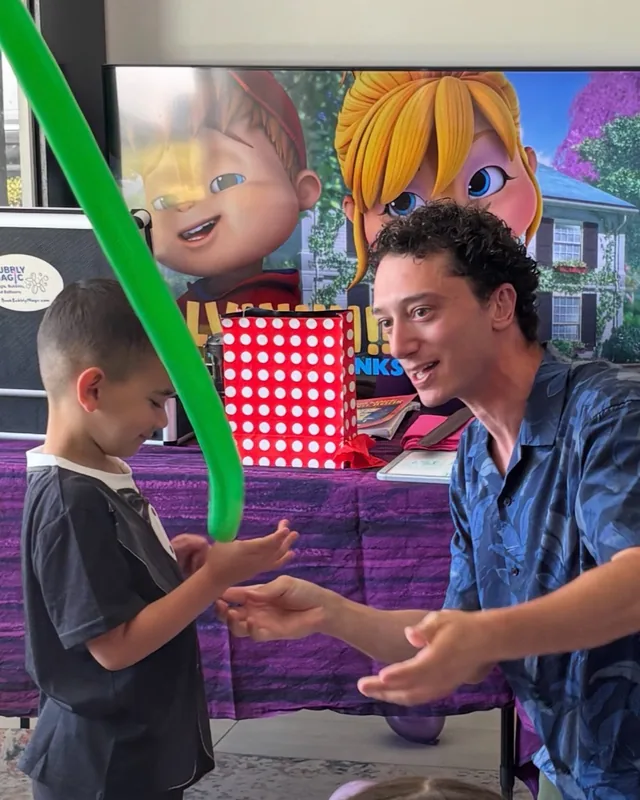 David performing magic for a child